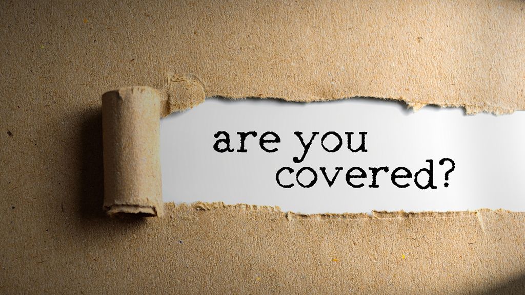 Paper with word are you covered - professional indemnity insurance concept